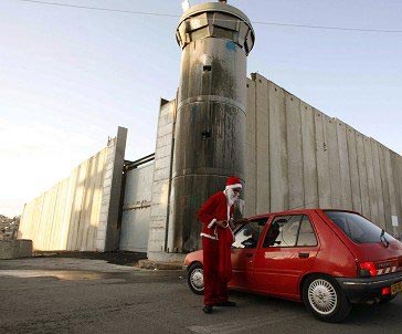 ‘Santa’ protests “Israeli” wall in Bilin