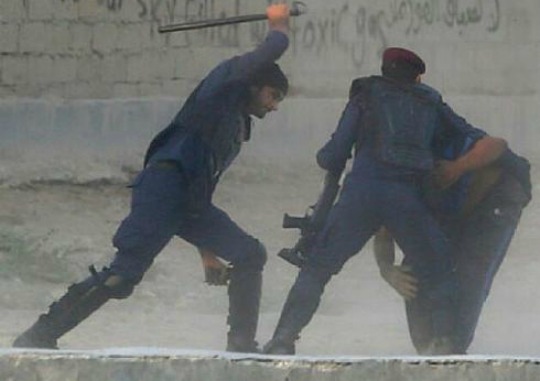 Bahraini protestor being beaten by police