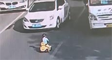 Toddler Rides Toy Bike through Rush Hour Traffic in China