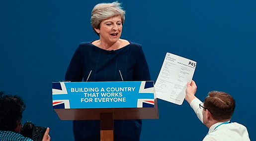 Protester Slams British PM’s Speech, Hands Her P45