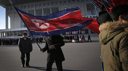 North Korean man carries flag during national celebrations 