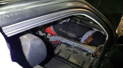 African migrant hiding in car dashboard