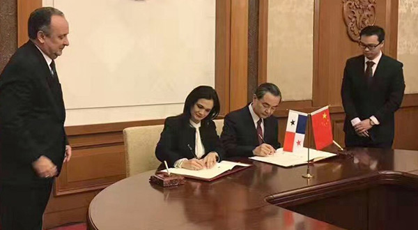 China's Foreign minister Wang Yi (third left) and his Panama counterpart Isabel Saint Malo sign documents in Beijing establishing formal diplomatic ties
