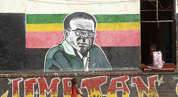 Children play near a painting of Zimbabwean President Robert Mugabe in Harare