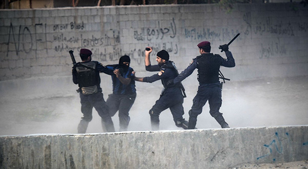 Bahraini security forces abusing a protester